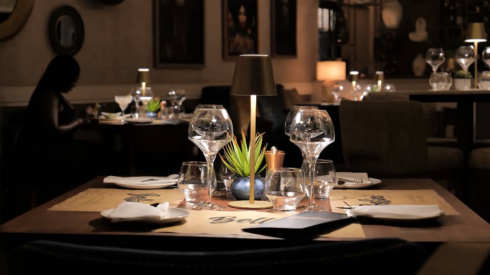 Inside Bellini, warm lighting over a set table